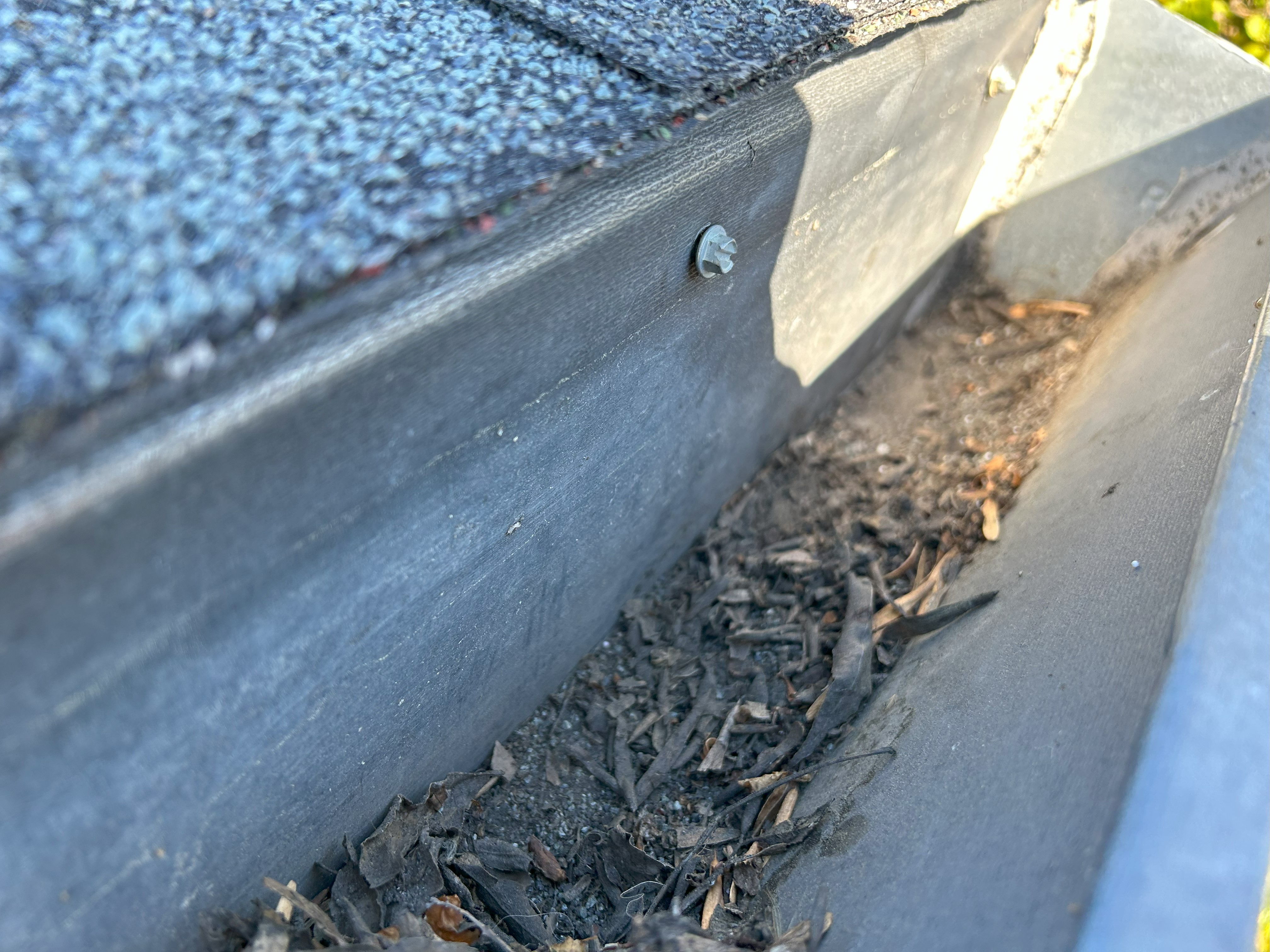 A Damaged Gutter With A Hole And Dirt Accumulated On Its Surface