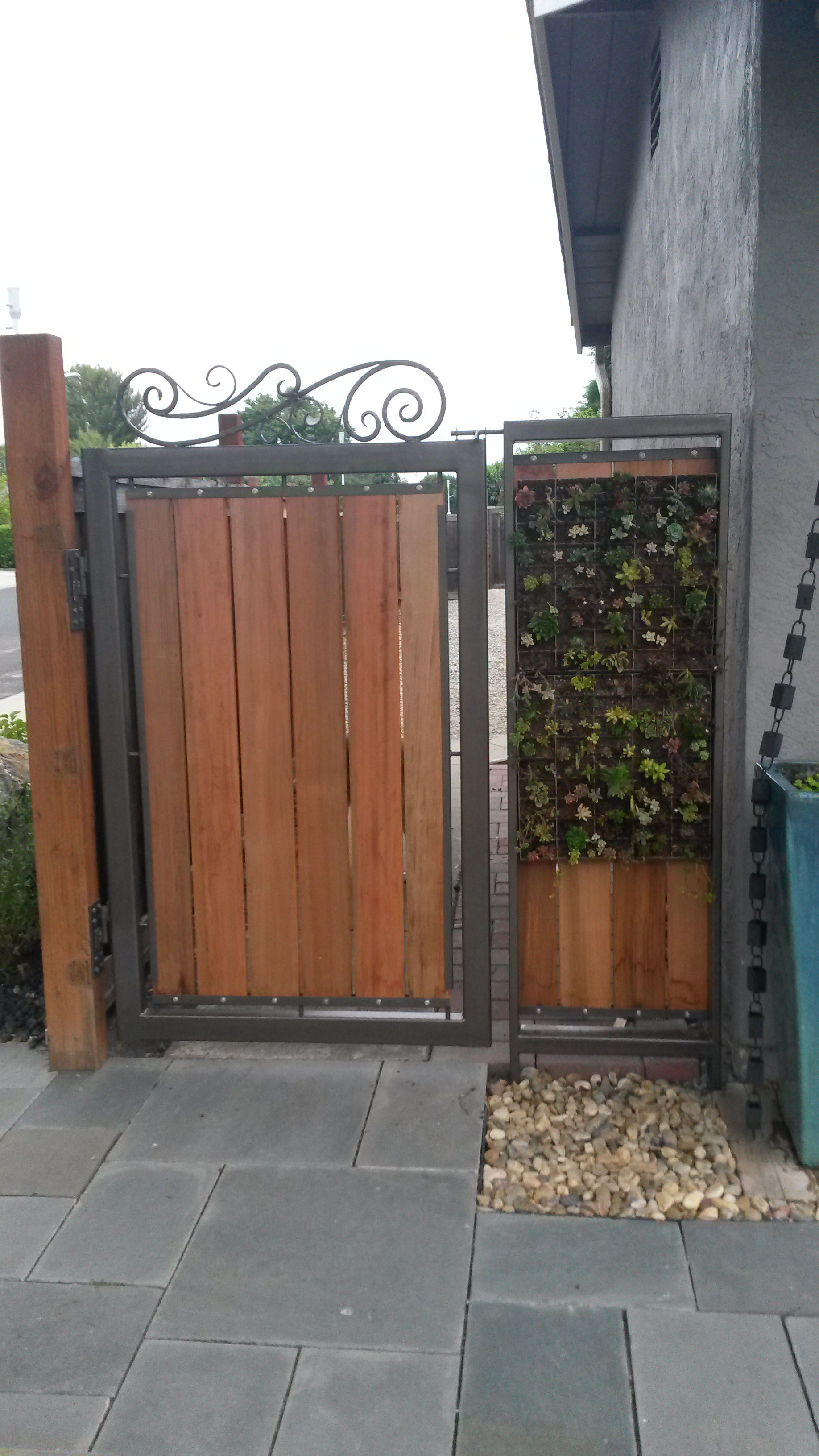 A Wooden Fence With A Green Wall And A Gate